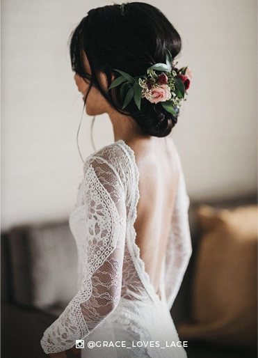 Bride wearing a lace wedding dress with an open back