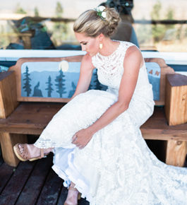 bride in white dress putting on her shoes
