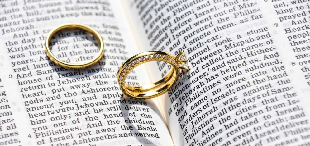 two wedding rings in a bible