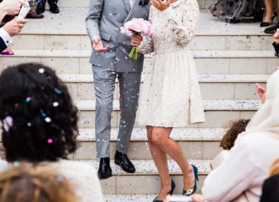 bride and groom exit ceremony surrounded by guests