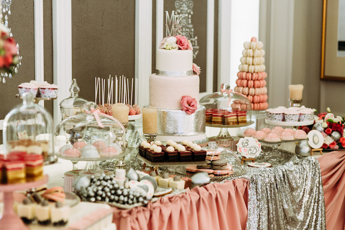 A dessert table at a wedding filled with cakes and other desserts