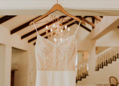 white wedding dress hanging in a house