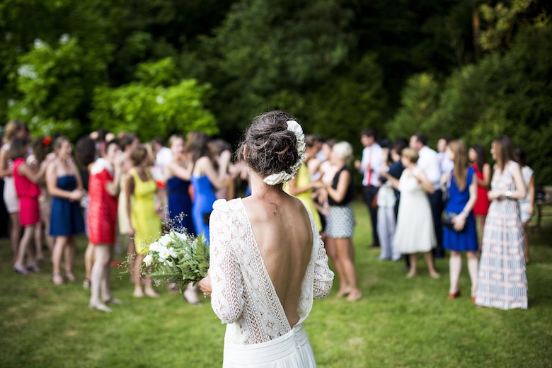 A bride looking at her crowd of wedding guests