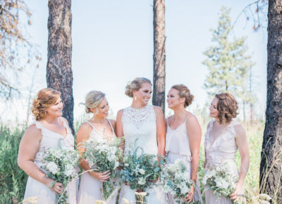 Happy bride with her bridesmaids, outdoor setting