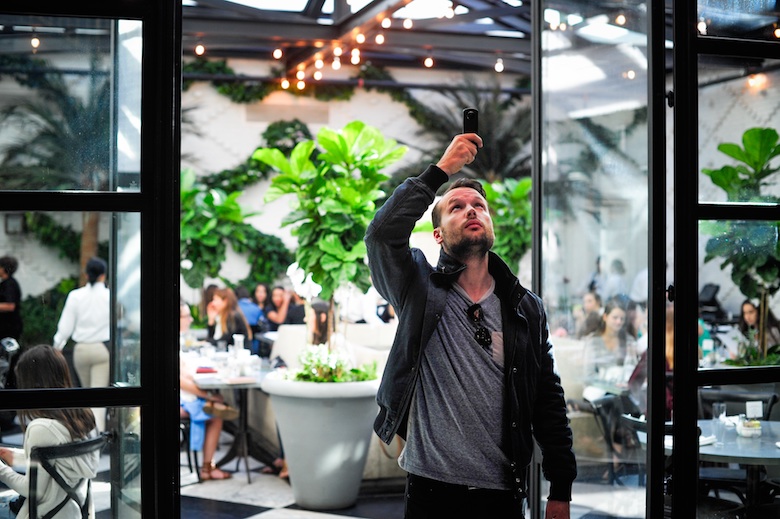 man taking selfie at an outdoor reception