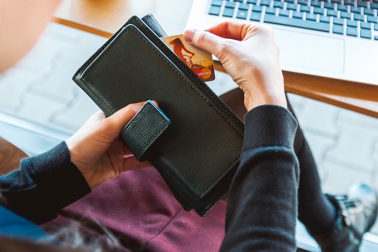 woman holding her credit card and wallet