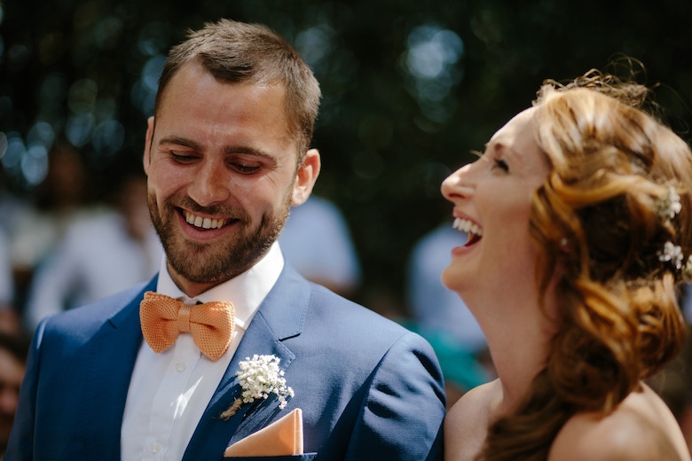 Bride and groom at the alter laughing
