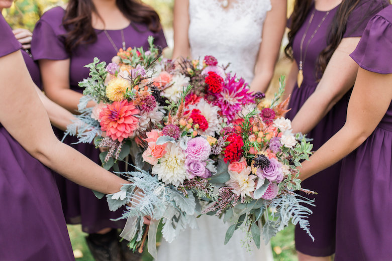 bridesmaids holding flowers together
