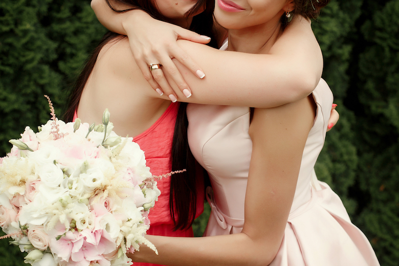 maid of honor & the bride share an embrace