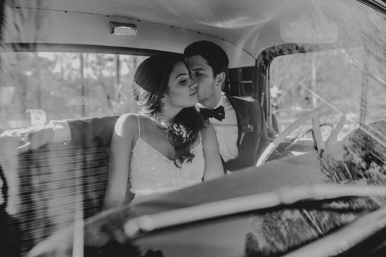 bride and groom car kiss