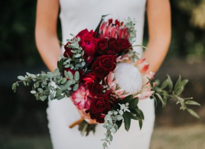 bride holding a beautiful red bouquet