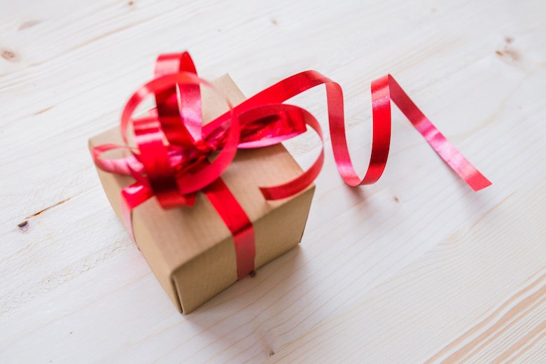 Brown paper package with a red ribbon