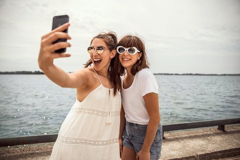 Girls taking a photo on a boardwalk