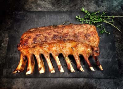 a beautiful rack of lamb served on a stone slab