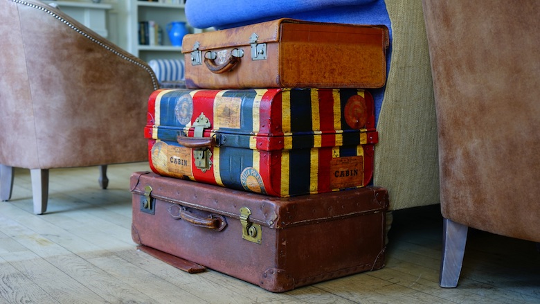 multiple suitcases stacked on top of each other