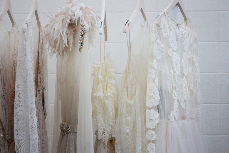 A closet filled with white dresses (for weddings or more) plus ballroom jewelry