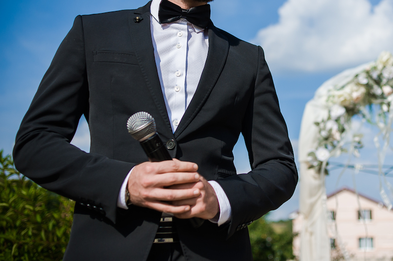 wedding host or speech giver holding a microphone at a wedding