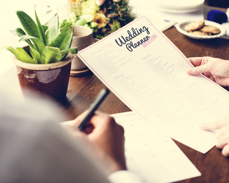 Hands holding a wedding planner checklist