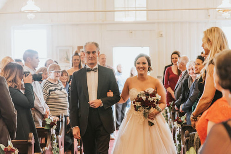 A proud father walking his daughter down the aisle for her wedding
