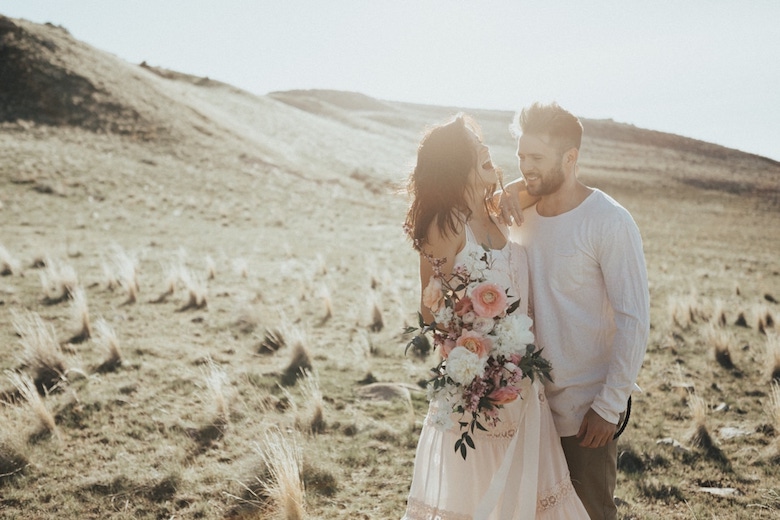 happy young engaged couple, wedding photos on a grassy plain