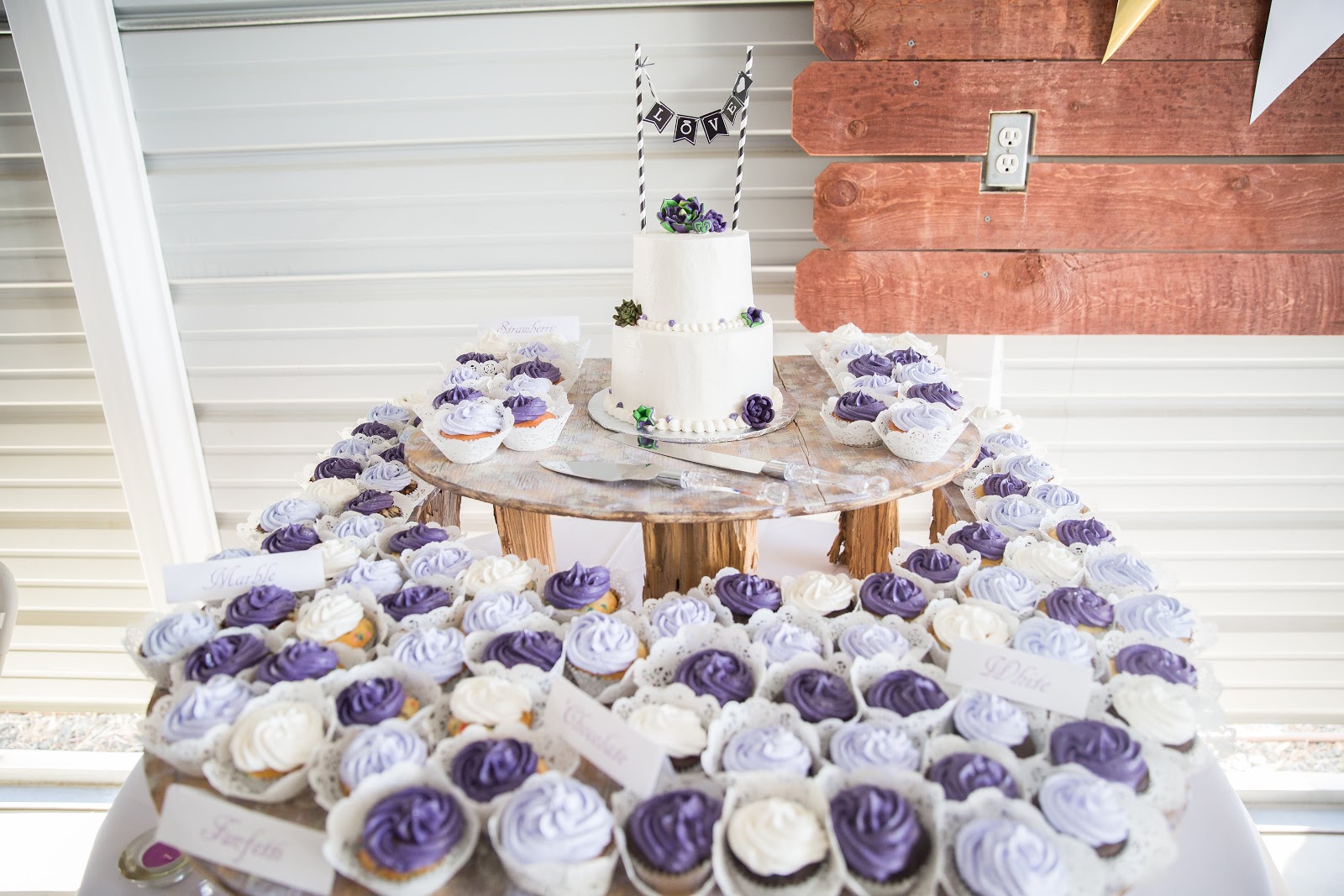 cupcake tower, purple and white frosting at a wedding