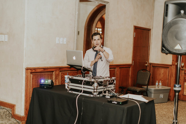 Wedding DJ calling out to the crowd, dj table
