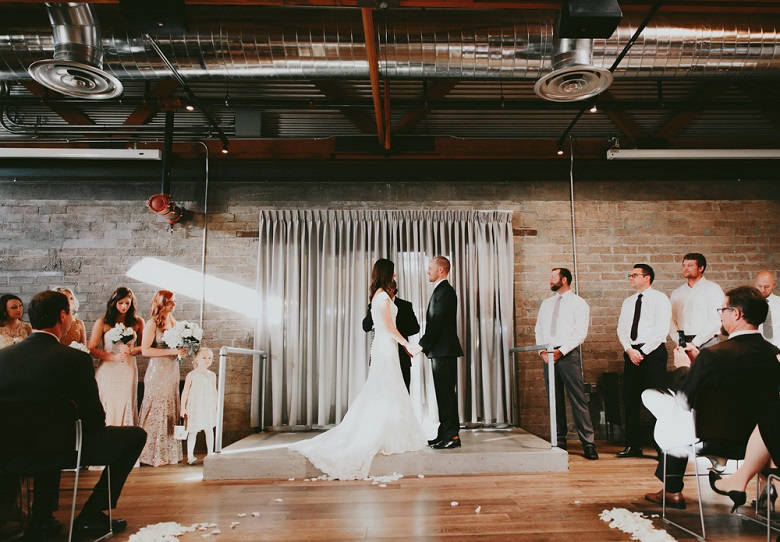 bride and groom against lush tulle drapes wedding backdrop