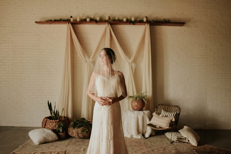 rustic wedding backdrop with a patterned rug and silk drapes