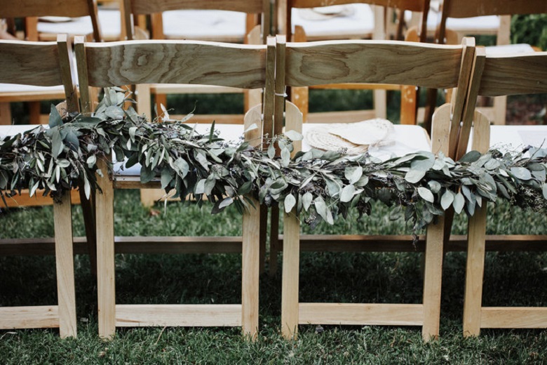 minimalist wedding chairs with greenery garlands