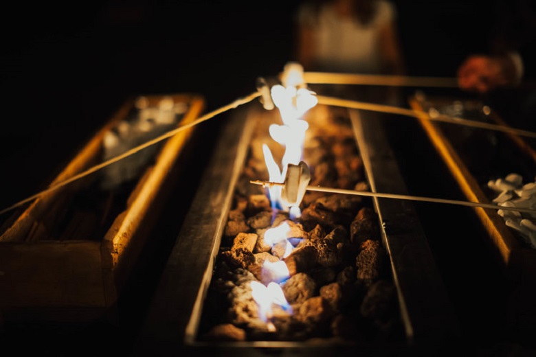 roasted marshmallows at a winter wedding bonfire 