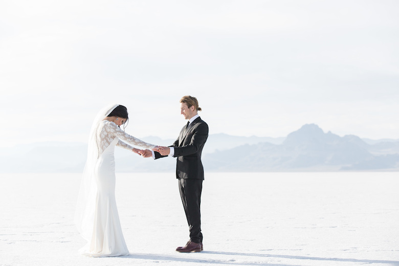 groom with bunned hair marries bride on icy tundra