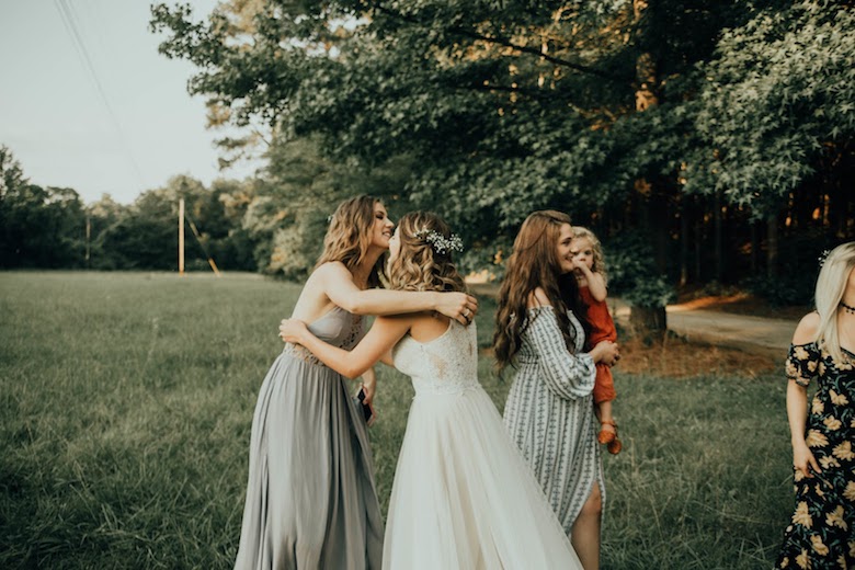 bohemian bride hugging her bridesmaid