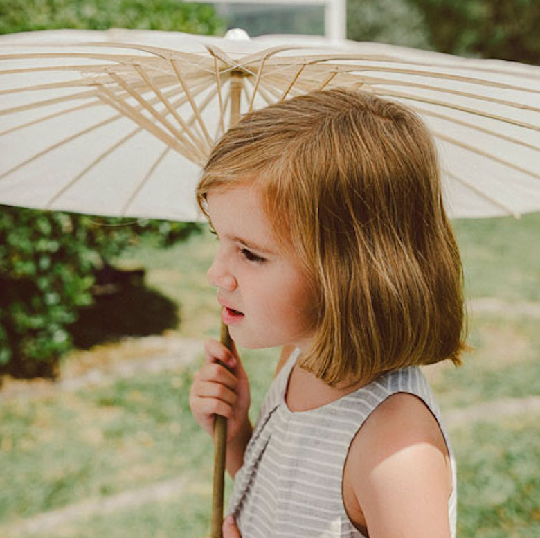 girl holding a wedding paper parasol