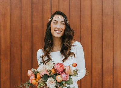smiling bride wearing a gypsy hair piece