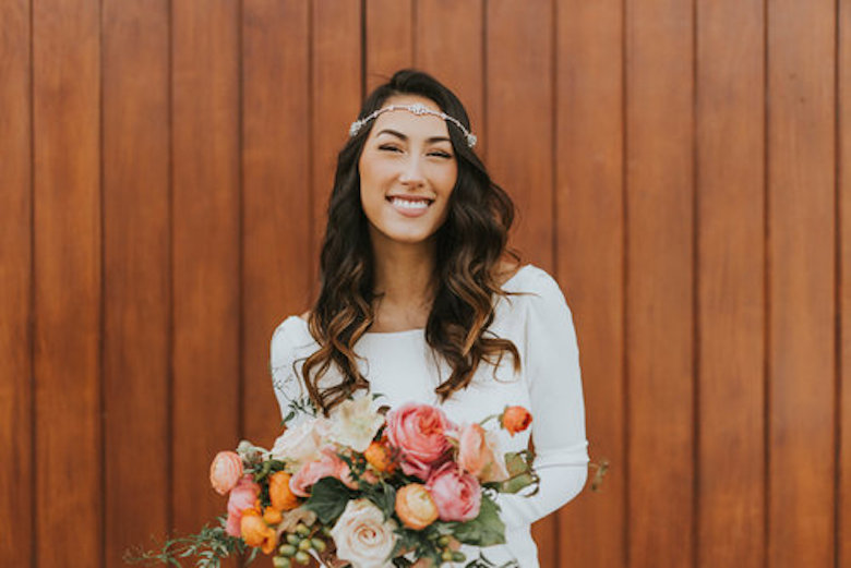 smiling bride wearing a gypsy hair piece