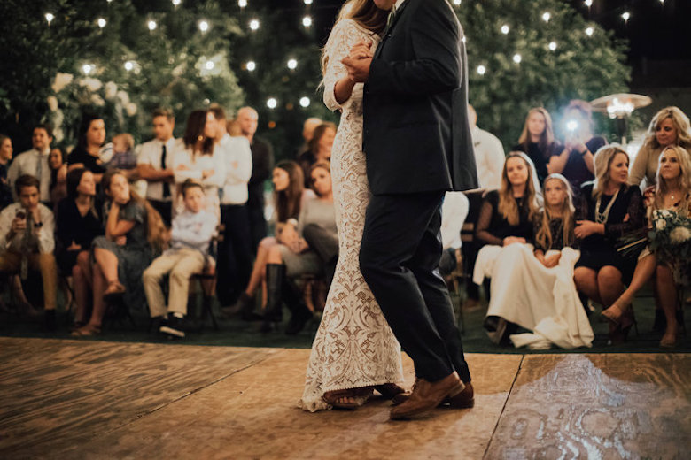 bride and groom's first dance on a wooden platform