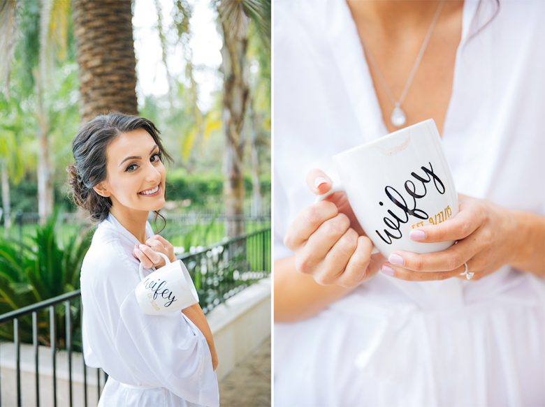 smiling bride in a white bathrobe, holding a mug that says "wifey"