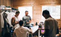 groomsmen getting dressed for the big day, indoors wood cabin setting