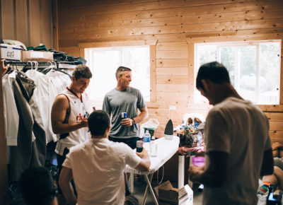 groomsmen getting dressed for the big day, indoors wood cabin setting