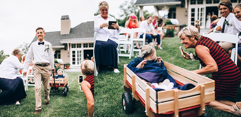 ring bearer dragging flower girl in a wagon down the aisle