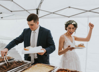 bride and groom eat food catering at wedding