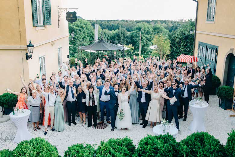 bride, groom and guests gathered at a wedding