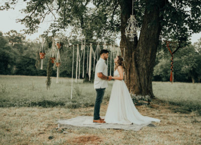 couple standing under a wedding tree