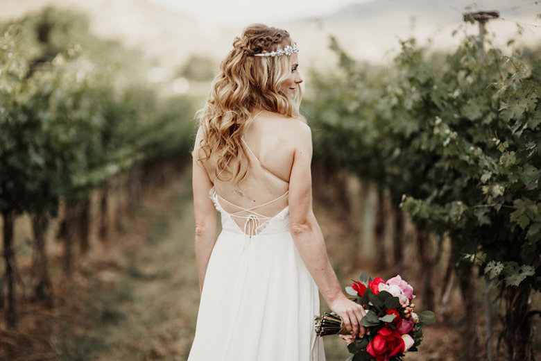 bride wearing a boho wedding dress and a waterfall braid