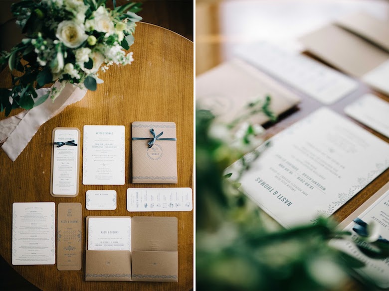 elegantly designed wedding invitations sitting on a mahogany desk