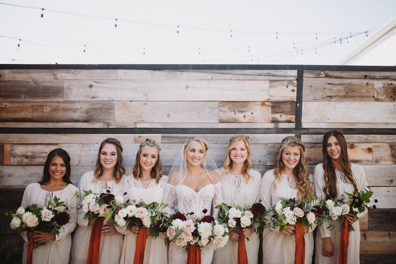 bride and bridesmaid lined up holding matching white bouquets