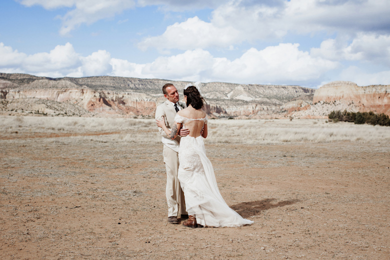 bride and groom embrace outdoors wedding