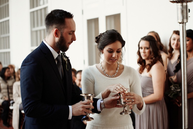 bride and groom drinking from golden cups