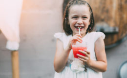 little girl drinking punch at a wedding