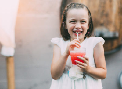 little girl drinking punch at a wedding